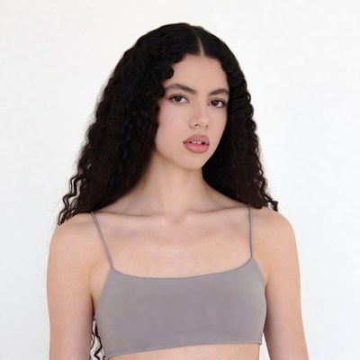 Woman with curly hair in gray top