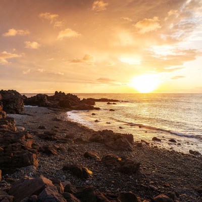 Sunset over rocky beach