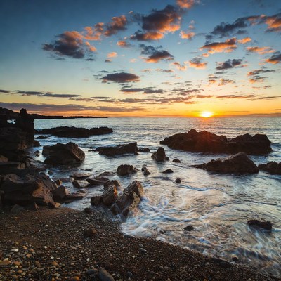 Sunset over rocky beach