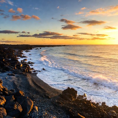 Sunset over black sand beach