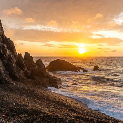 Sunset over rocky beach