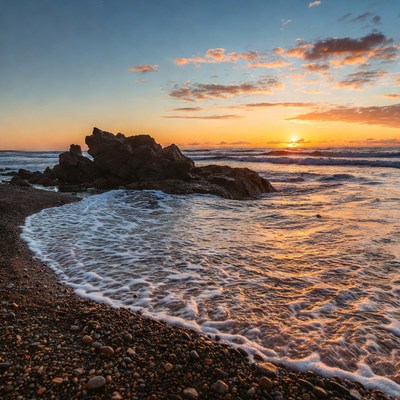 Sunset over rocky beach
