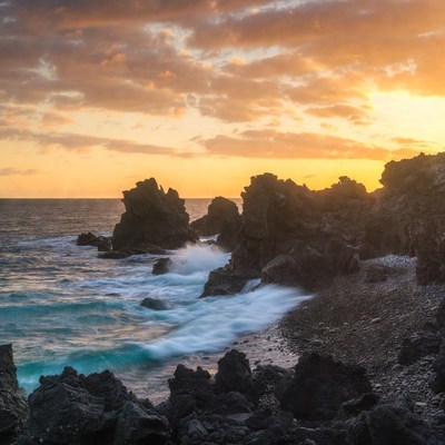 Dramatic Sunset Over Rocky Ocean Shore