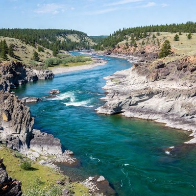 River Flowing Through Forested Canyon