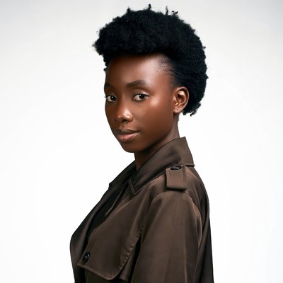 African woman in brown trench coat