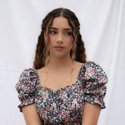 Young woman in floral off-shoulder top