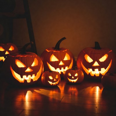 Group of lit jack-o-lanterns on floor