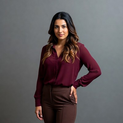 Smiling woman in maroon blouse and pants