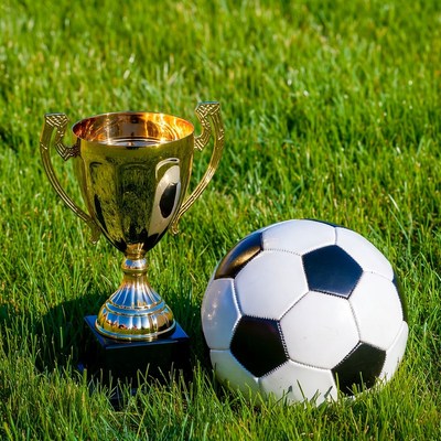 Gold Trophy and Soccer Ball on Grass
