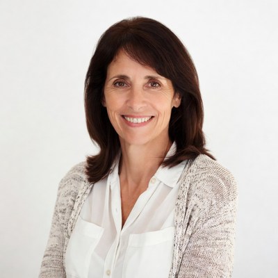 Smiling woman in white shirt and cardigan