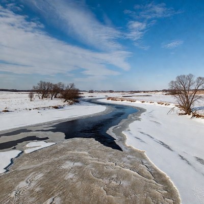 Frozen River in Snowy Landscape