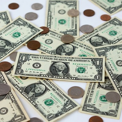 US Dollars and Coins Scattered