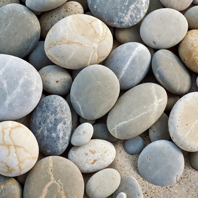 Pile of Smooth Pebbles on Sand