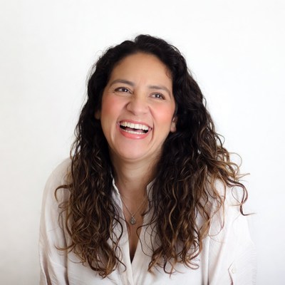 Latina woman smiling with curly hair