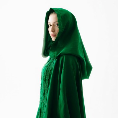 Woman in green hooded cloak
