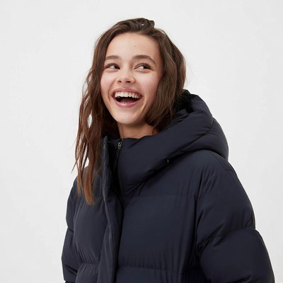 Teen girl smiling in navy puffer jacket