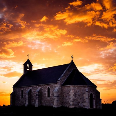 Church silhouetted against sunset sky