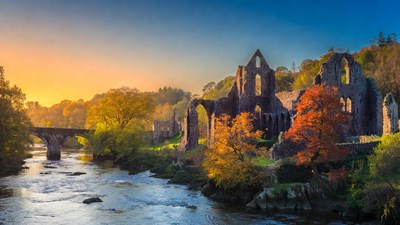 Ruins and Bridge over River at Sunset
