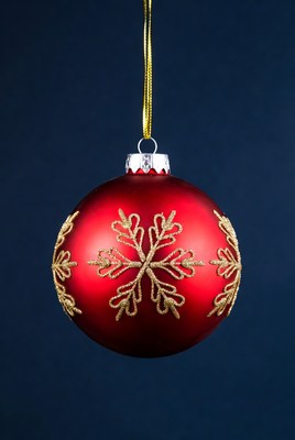 Red Christmas ornament with gold snowflakes