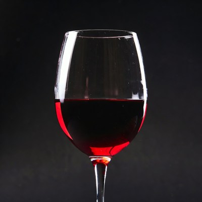 Red wine glass on black background