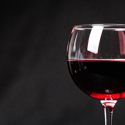 Red wine glass on black background