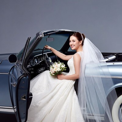 Bride driving vintage convertible car