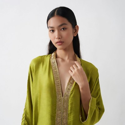 Asian woman in green embroidered dress