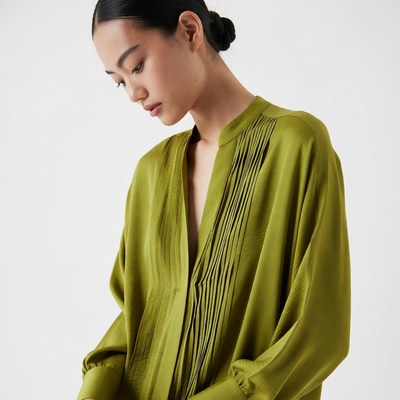 Asian woman in green silk blouse