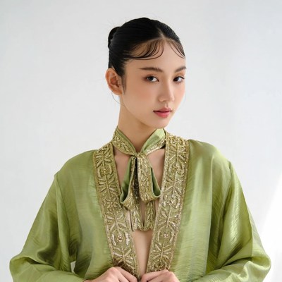 Asian woman in green embroidered jacket