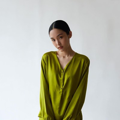 Asian woman in green silk blouse