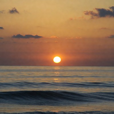 Sunset over ocean waves