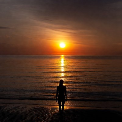 Silhouette woman at sunset beach