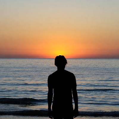 Silhouette of man at sunset beach