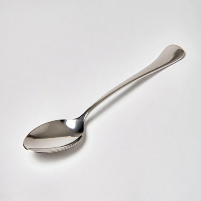 Shiny silver spoon on white background