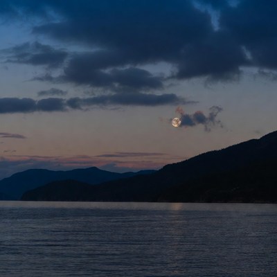 Moonrise over mountains and lake