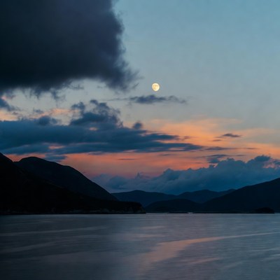 Moon over mountains and lake