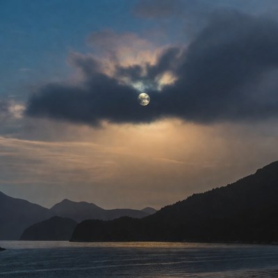 Full Moon Through Clouds Over Fjord