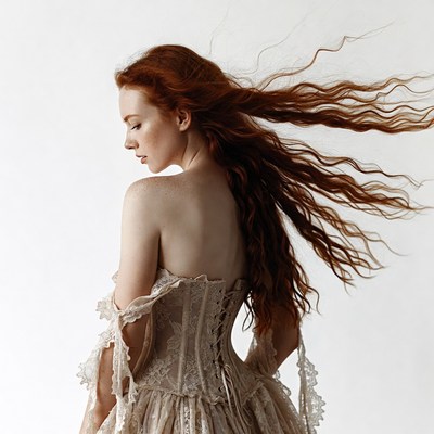 Redhead woman in lace corset gown