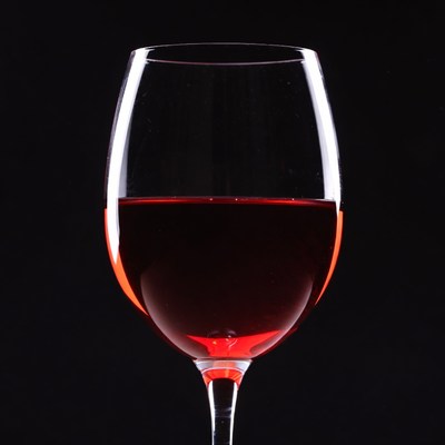 Red wine glass on black background