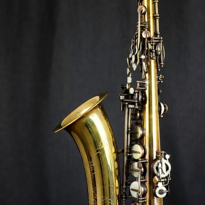 Brass saxophone on black background