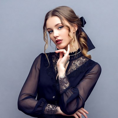 Woman in black lace blouse with bow