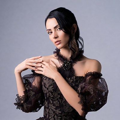 Woman in black lace off-shoulder dress