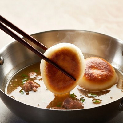 Chopsticks Picking Dumplings in Soup