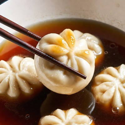 Chopsticks Picking Dumpling in Soup