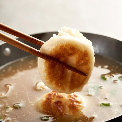 Chopsticks Lifting Dumpling from Soup