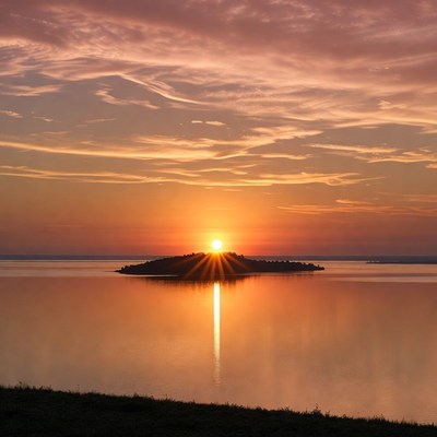 Sunset over island in lake