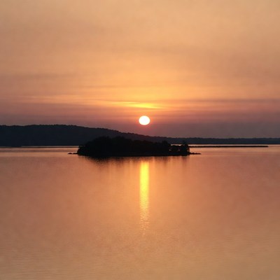 Sunset over island in lake