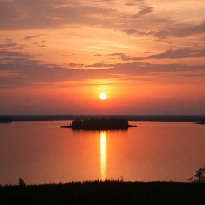 Sunset over island in lake