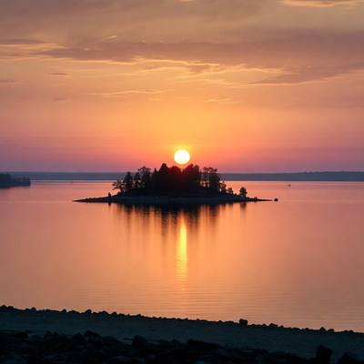 Sunset over island in lake