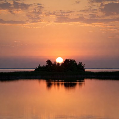 Sunset over island in lake